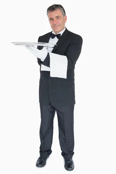 Happy waiter with silver tray and towel — Stock Photo, Image