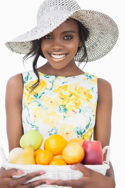Woman standing holding a fruit basket — Stock Photo, Image