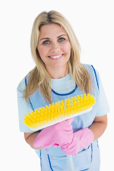 Cleaner woman holding a yellow broom — Stock Photo, Image