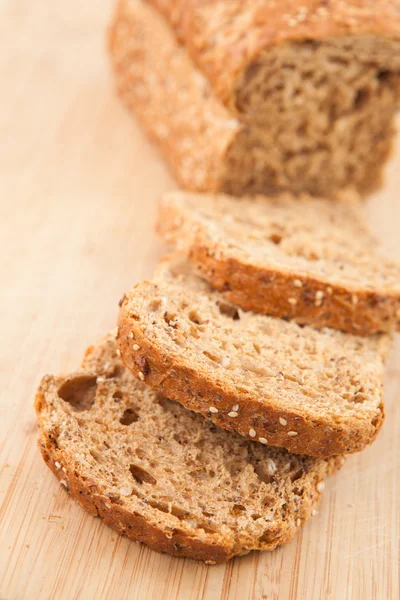 Partially sliced brown bread — Stock Photo, Image