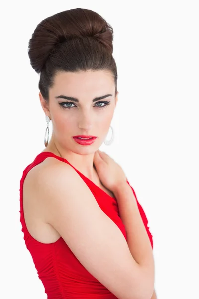 Woman with red dress touching her shoulder — Stock Photo, Image