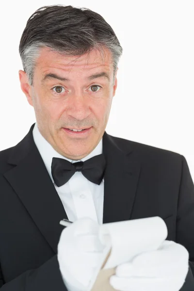 Surprised waiter writing something into notebook — Stock Photo, Image