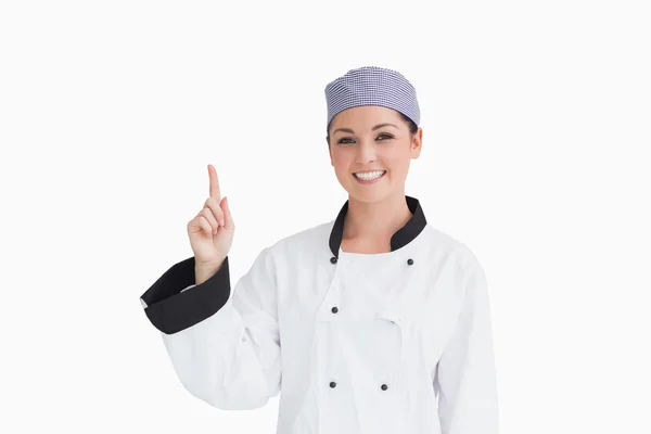 Smiling chef pointing up — Stock fotografie