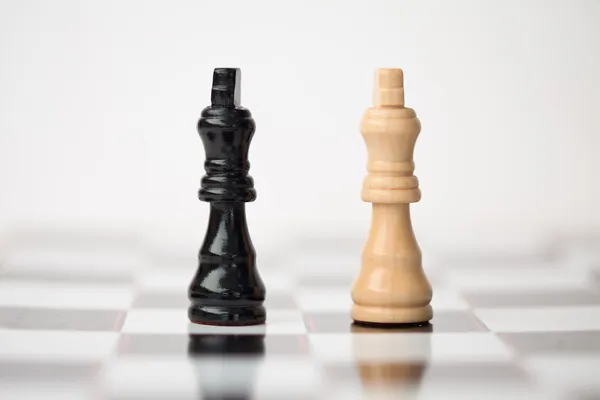 Chess pieces standing at the chessboard beside each other — Stock Photo, Image