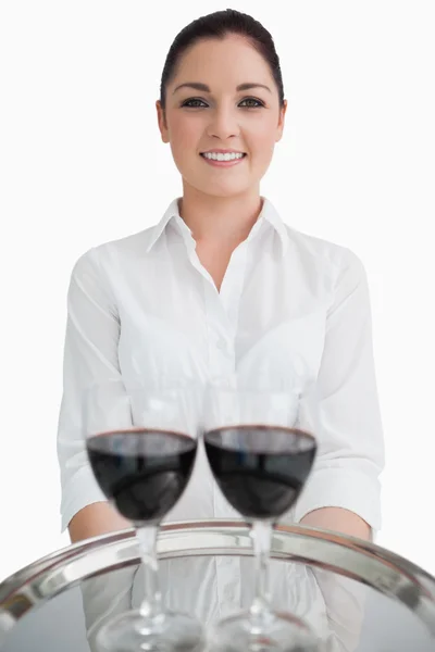 Waitress holding tray with glasses of wine Stock Image