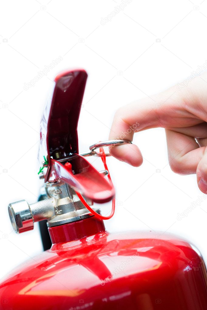 Hand pulling safety pin from fire extinguisher — Stock Photo