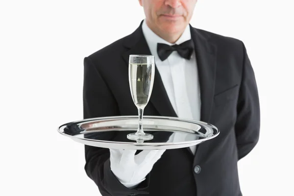 Man in suit serving glass with champagne — Stock Photo, Image