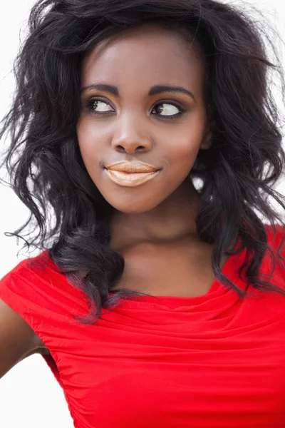 Woman standing smiling wearing a dress — Stock Photo, Image