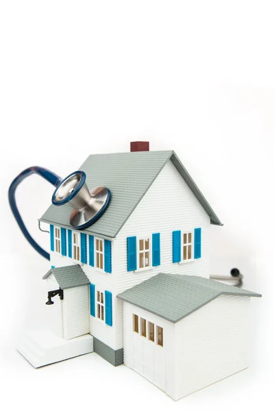 Blue stethoscope taking care of the house — Stock Photo, Image