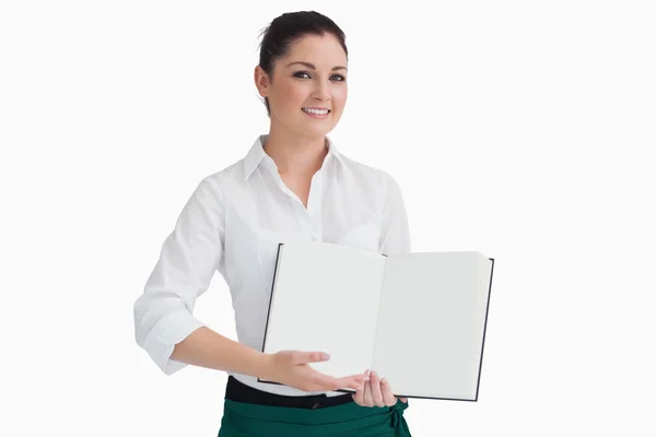 Waitress showing open book — Stock Photo, Image