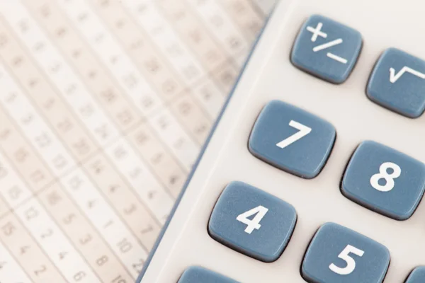 Calculator on maths tables — Stock Photo, Image