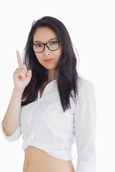 Woman in glasses pointing up — Stock Photo, Image