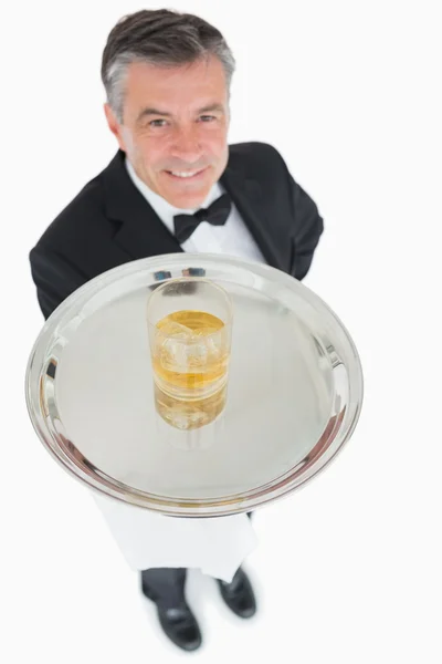 Waiter offering whiskey on tray — Stock Photo, Image