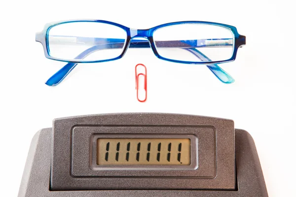 Sector of calculator display with glasses and paper clip — Stock Photo, Image
