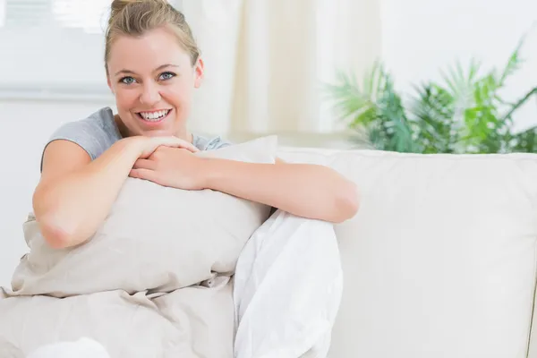 Cheerful woman holding a pillow — Stock Photo, Image