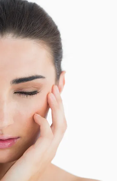 Woman having eyes closed while touching her cheek — Stock Photo, Image