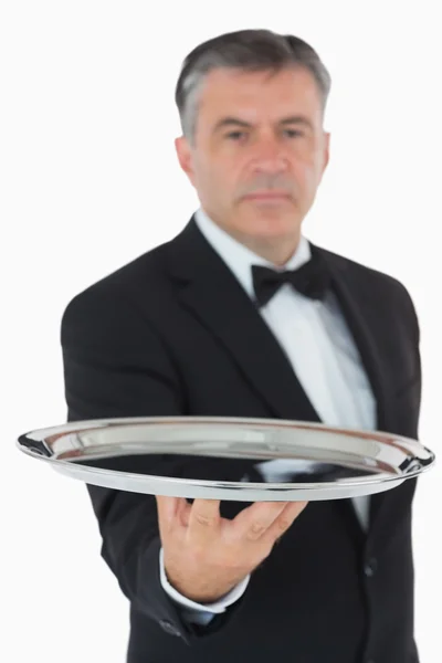 Serious waiter holding tray — Stock Photo, Image