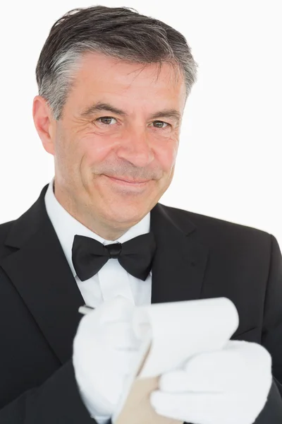 Waiter looking into the camera while is writing into the noteboo — Stock Photo, Image