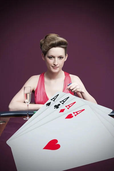 Attractive gambler betting on four aces — Stock Photo, Image