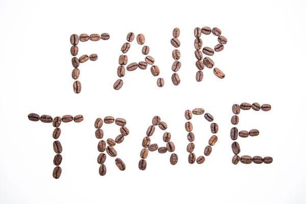 Fair trade spelled out in coffee beans — Stock Photo, Image