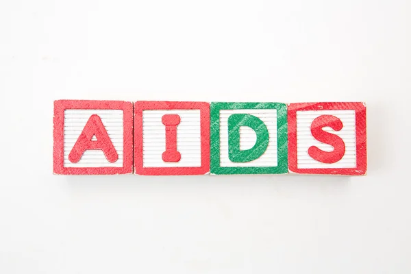 Wood blocks spelling out aids in green and red — Stock Photo, Image