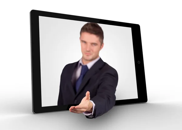 Businessman reaching out from tablet for a handshake — Stock Photo, Image