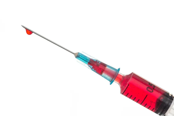 Syringe dripping blood — Stock Photo, Image