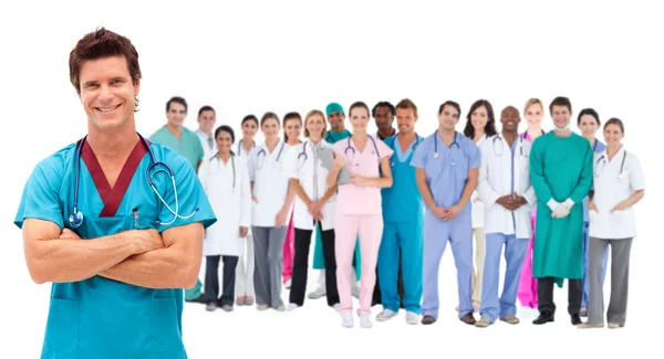 Smiling surgeon in front of a team of doctors standing together — Zdjęcie stockowe