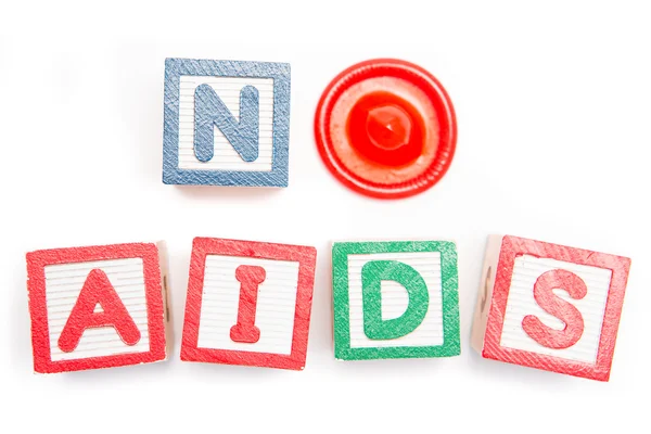 No aids spelled out in blocks and a condom — Stock Photo, Image