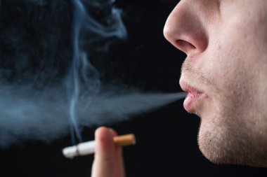 Man exhaling cigarette smoke clipart
