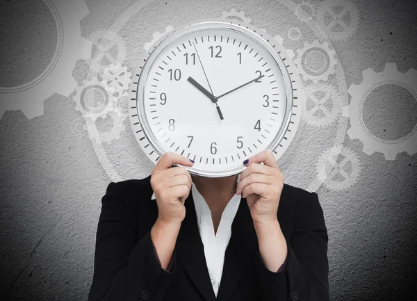 Mujer de negocios escondiendo su cara con reloj — Foto de Stock