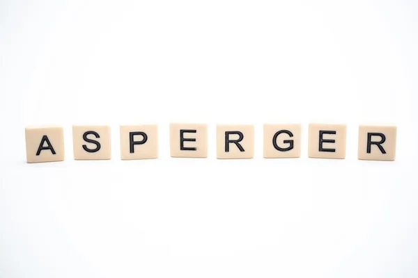 Asperger spelled out in plastic letter pieces — Stock Photo, Image