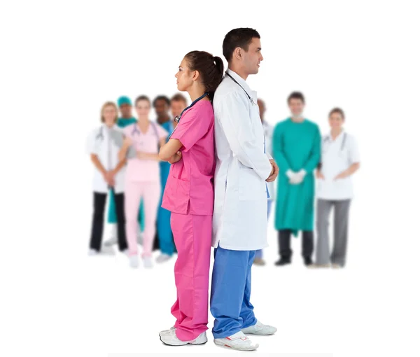 Doctor and nurse standing back to back — Stock Photo, Image