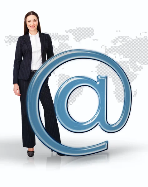 Businesswoman standing by email at symbol — Stock Photo, Image