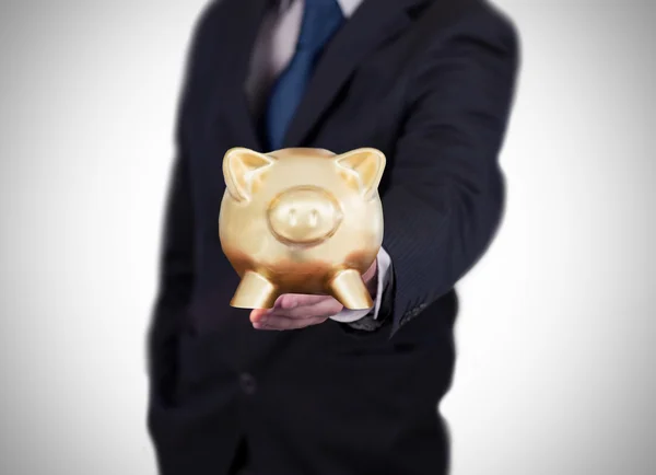 Businessman showing a piggy bank — Stock Photo, Image