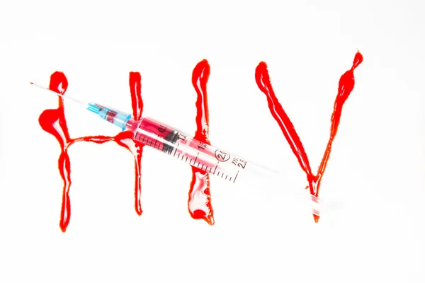 HIV soletrado em sangue e seringa — Fotografia de Stock