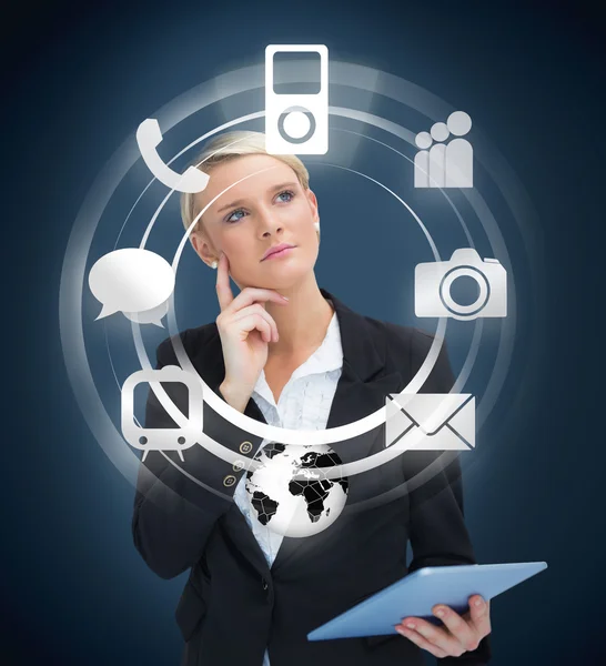 Thoughtful businesswoman with tablet pc considering various applications — Stock Photo, Image