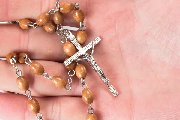 Rosary beads in someones hand — Stock Photo, Image
