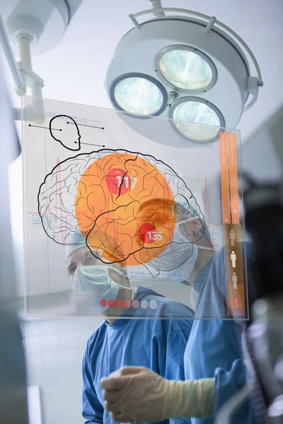 Two surgeons looking at the brain on an interface — Stock Photo, Image