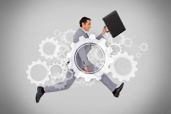 Businessman running with briefcase on grey background — Stock Photo, Image