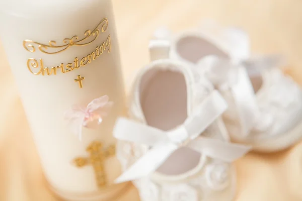 Baptism candle and baby booties — Stock Photo, Image
