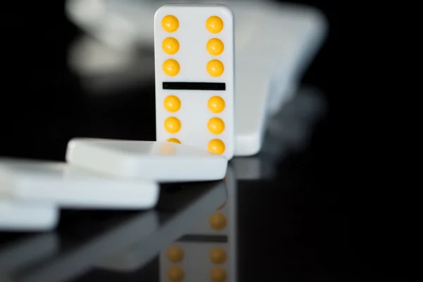 One yellow domino left standing — Stock Photo, Image