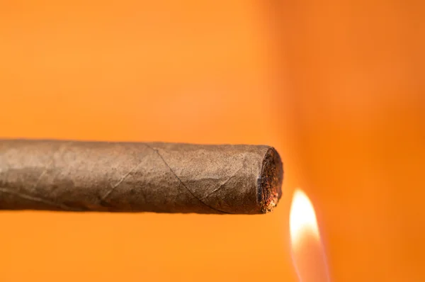 Someone lighting a cigar — Stock Photo, Image