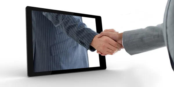 Businessman reaching out from tablet and shaking hands — Stock Photo, Image