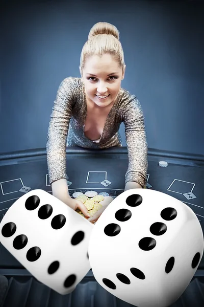 Blonde woman grabbing chips with digital dice — Stock Photo, Image