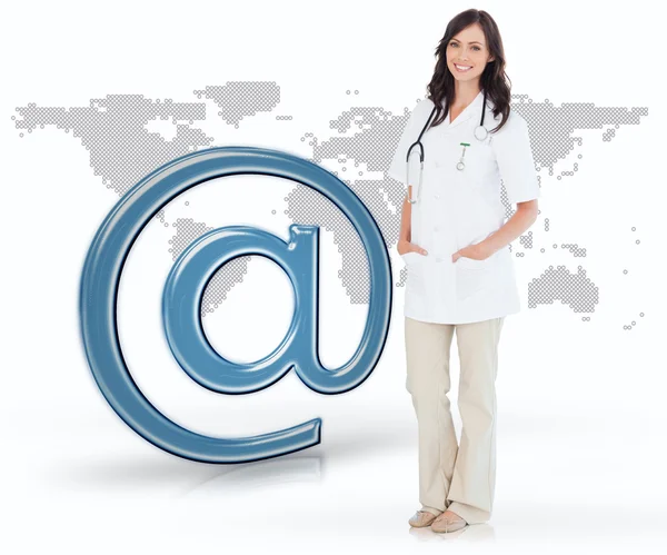 Nurse standing by digital email at symbol — Stock Photo, Image