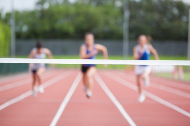 Athletes running towards finish line clipart