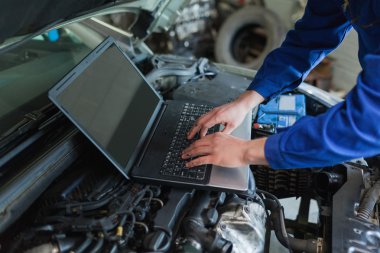 Auto mechanic using laptop clipart