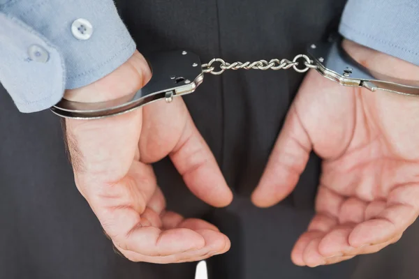 Close-up of arrested businessman — Stock Photo, Image