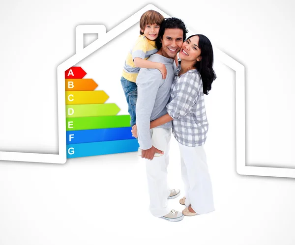 Smiling family standing with a house illustration with energy ra — Stock Photo, Image